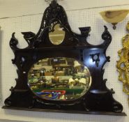 A mahogany framed overmantel mirror, the upper section with oval mirror plate and pierced carved