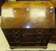 An early 19th Century mahogany bureau, the sloping fall enclosing a basic fitted interior over