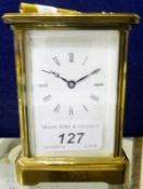 A circa 1900 French lacquered brass cased carriage clock with plain enamel dial and Roman numerals