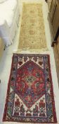 A Caucasian rug, the central grey and red medallion on a patterned burgundy field within a blue,