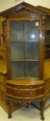 A 19th Century Continental pine corner cabinet, the upper section with glazed and barred door