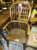 An elm seated Windsor chair with crinoline stretcher to base