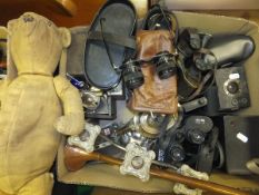 A box of miscellaneous items to include vintage binoculars, cameras, a brass horn, a pair of Kershaw