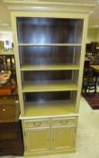 A Villeroy & Boch yellow and cream painted kitchen dresser with four open shelves above two