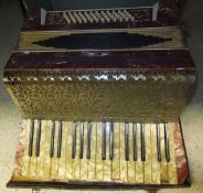 A Scarlatti accordion with red mother of pearl effect decoration, housed in a black carrying case