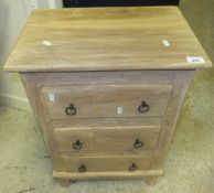 A pine three drawer bedside cabinet