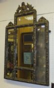 A 19th Century giltwood and gesso framed overmantel mirror with multiple plates within an egg and