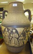 A large German pottery vase with relief decoration of figures beneath arches