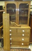 A vintage pine chest of two short and three long drawers with glazed double door cabinet enclosing