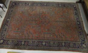 An Ushak carpet, the centre salmon field with stylised floral patterns in blue, mustard, cream and