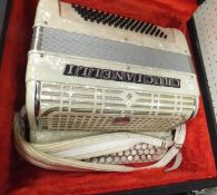 A Crucianelli accordion with cream mother of pearl effect finish, housed in a black carrying case