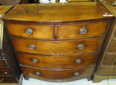 An early 19th Century mahogany bow fronted chest of two short and three long graduated drawers on