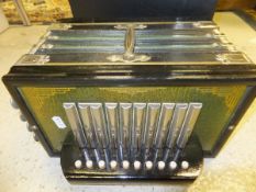 A 1930's accordion with green and gilt decoration, together with an associated black plastic case