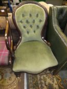 A Victorian walnut framed nursing chair with buttoned back, upholstered in pale green fabric