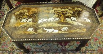 An early 20th Century Anglo-Indian coffee table inlaid with elephants amongst foliage, the legs