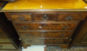 A mahogany chest of drawers in the George III taste, the plain top above three short and three