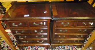 A pair of modern reproduction mahogany miniature chests of two short and three long graduated