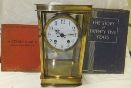 A brass cased four glass mantel clock with circular enamel dial and Arabic numerals, together with