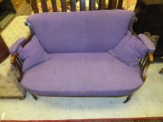 A Victorian rosewood framed two seat sofa, upholstered in purple fabric