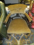 An early 20th Century salon chair with cabriole front legs, upholstered in a dark mustard fabric