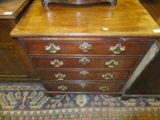 A George III bachelor chest, the rectangular top above a brushing slide over four long graduated