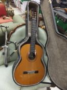 A Manuel Rodriquez No. 2449 Spanish guitar, housed in a black carrying case, together with a chromed