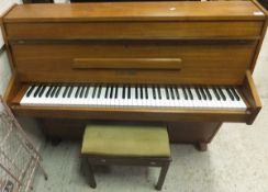 A mid 20th Century teak cased upright piano, the iron framed over strung movement by Zender,