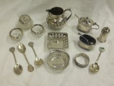 A box of silver wares to include a Victorian silver cream jug, a George V silver three piece cruet