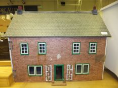 A mid 20th Century doll's house with brick effect front