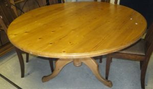 A pine circular pedestal breakfast table