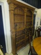 A pine open bookcase with arch and fluted pilaster decoration