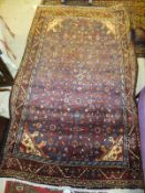A Mahal rug, the centre blue field with all-over repeating pattern in red, pink, madder and cream,