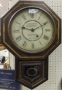 A mahogany cased wall clock by Seth Thomas USA and inscribed "J. W. Terry of Brighton" with Roman