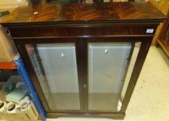 A mahogany display cabinet with two glazed bevel edged doors, adjustable glass shelves, on bracket