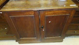 A 19th Century mahogany cupboard with two panelled doors opening to reveal various shelving on a
