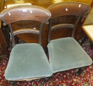 A pair of 19th Century mahogany framed dining chairs with upholstered seats on fluted front legs