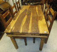 A modern Indian hardwood dining table and six matching chairs