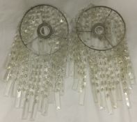 A pair of glass lamp lustres