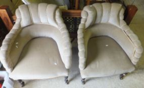 A pair of 19th century salon chairs raised on turned and ringed legs to castors, upholstered in