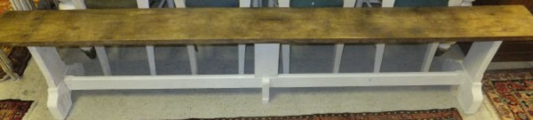 A long oak bench with cream painted supports   CONDITION REPORTS  General wear, scuffs, various