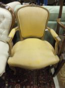 A beech wood fauteuille / elbow chair in the Louis XV manner, with gold coloured upholstery