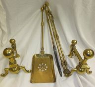 Two brass fire dogs, together with brass fire tools to include shovel, poker and tongs