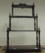 A rosewood four tier hanging wall shelf with barley twist supports