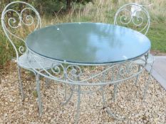 A green painted garden table with glass top and two matching chairs