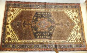 A Hamadan rug, the central blue and terracotta medallion on a madder patterned ground within