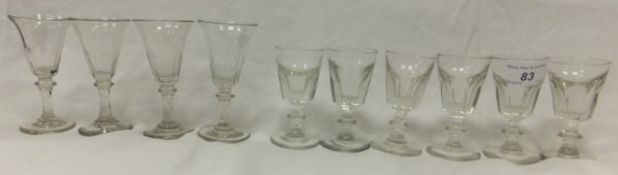 A set of four 19th Century wine glasses with facet cut sides, together with a set of six similar