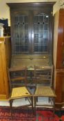An oak Jacobean style two drawer bureau bookcase with leaded glazed doors to top, together with