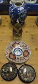 Two Pratt ware pot lids- one depicting two dogs in an interior setting beside a table and chair