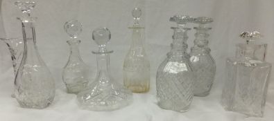 Seven glass decanters to include cut glass ship's decanter, together with two clear glass vases