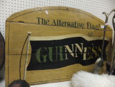 A dome-topped painted wooden Guinness sign, a circular painted wooden "Guinness is Good for You"